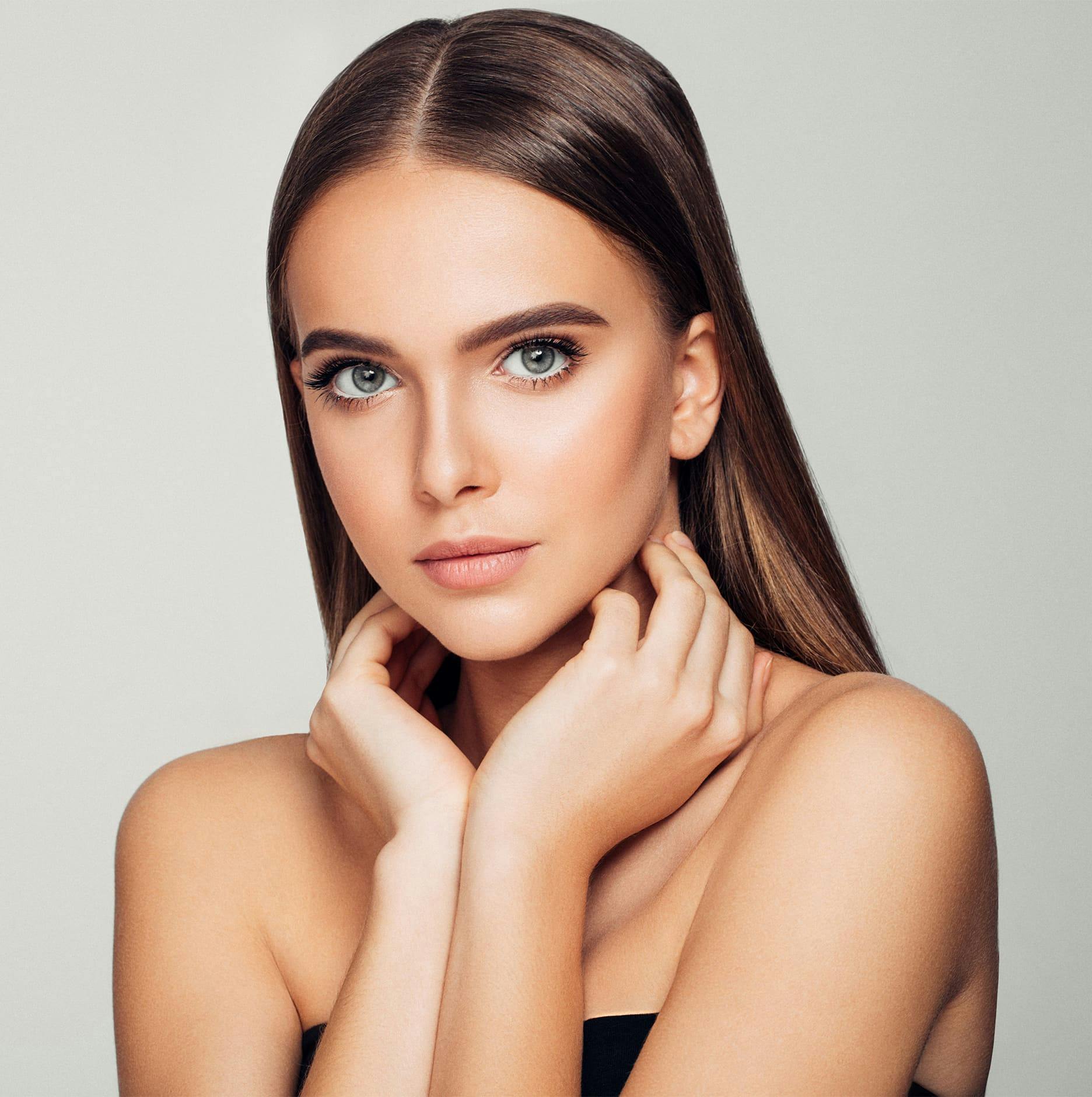 woman with hands on her neck