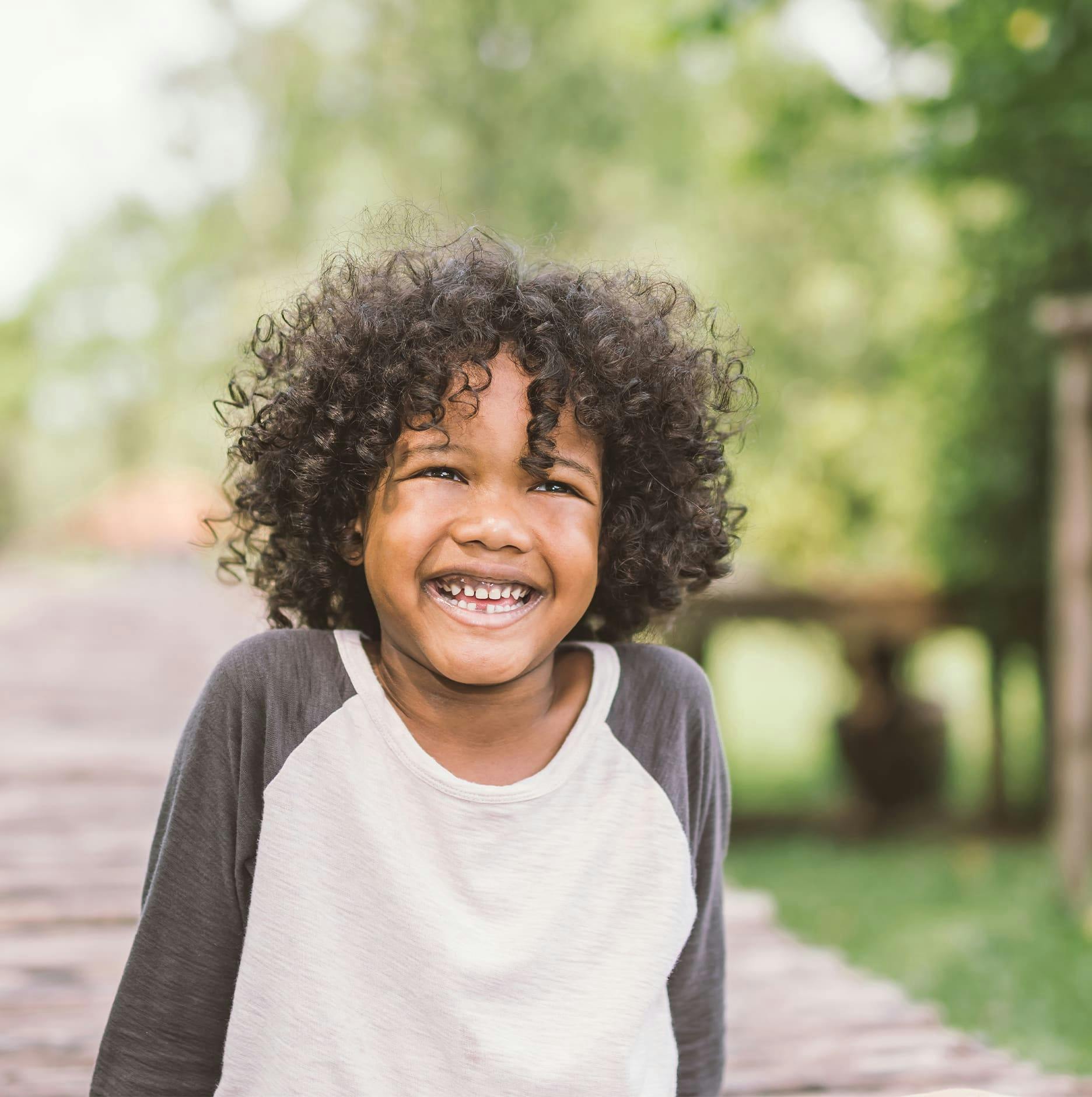 boy with curly hair smiling