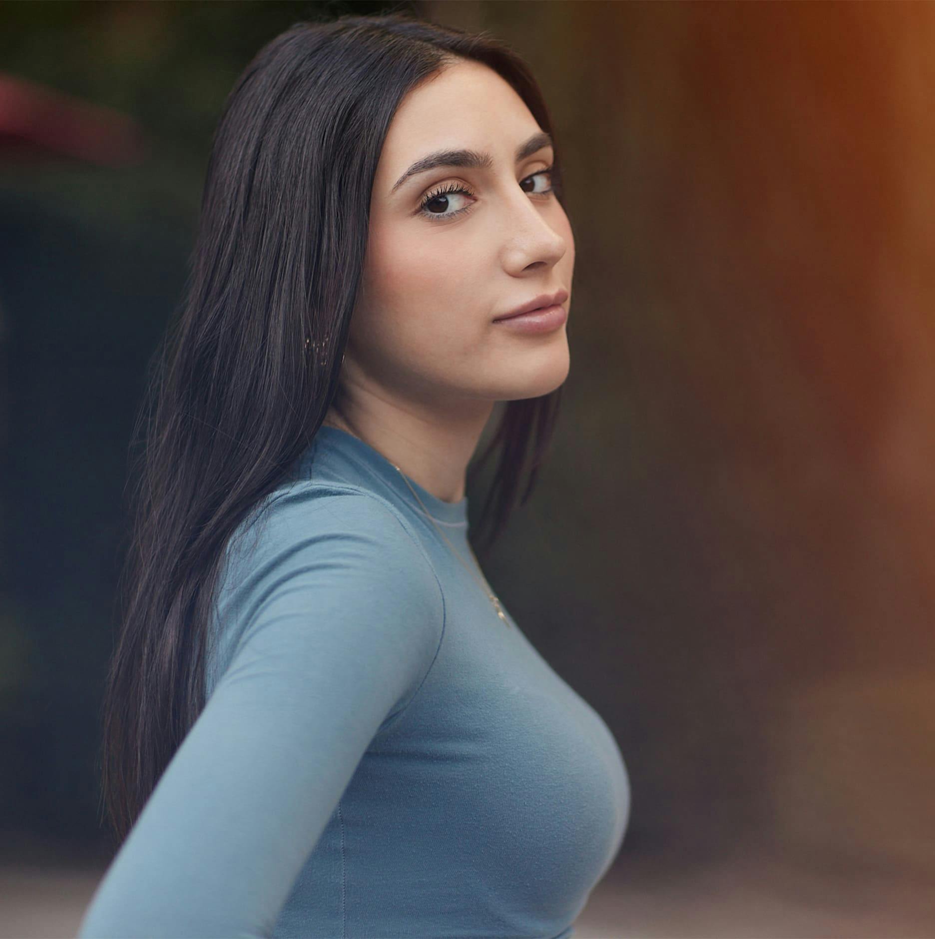 woman looking at camera yet her body faces the right