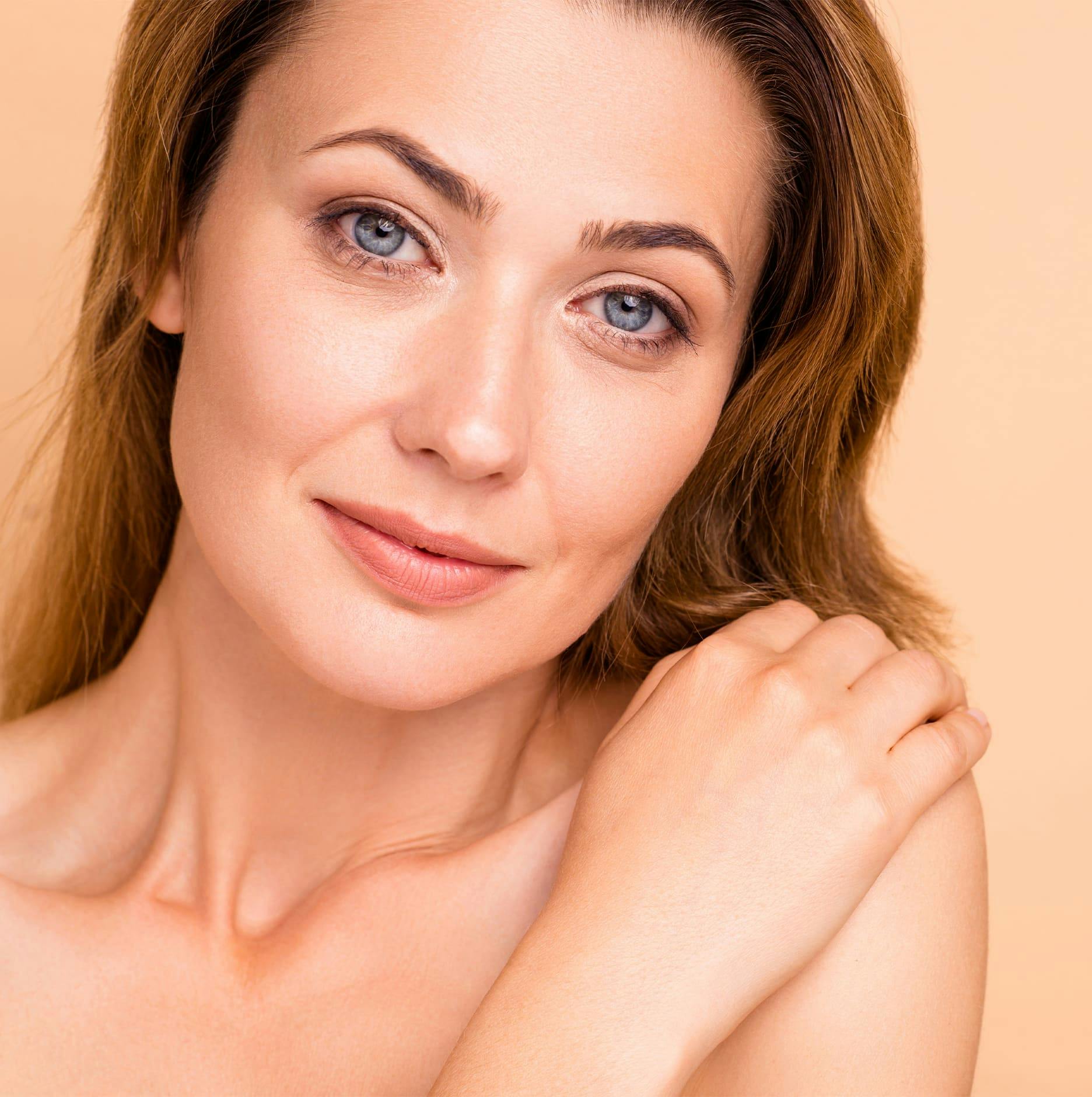 woman with bright blue eyes with hand on her shoulder