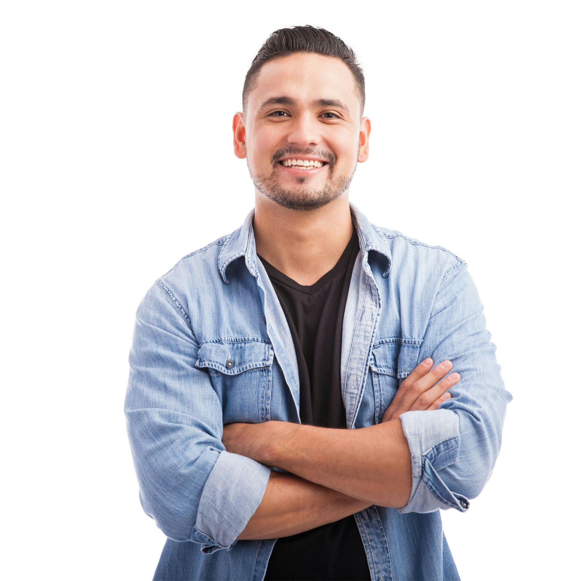 man smiling and crossing his arms with white background