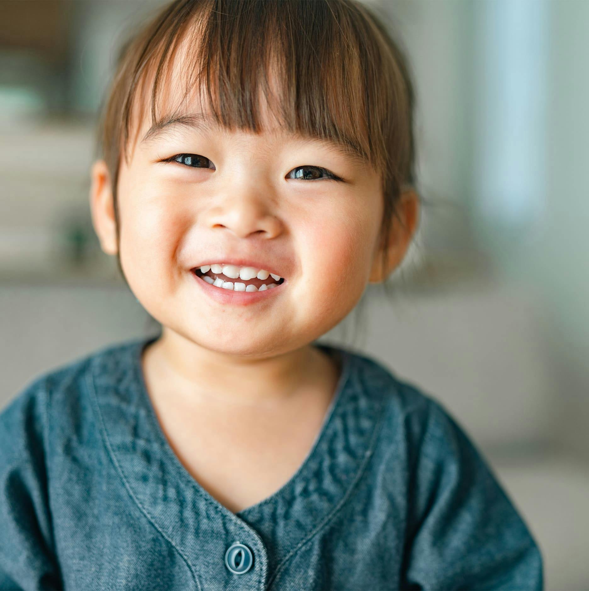 little girl with bangs smiling