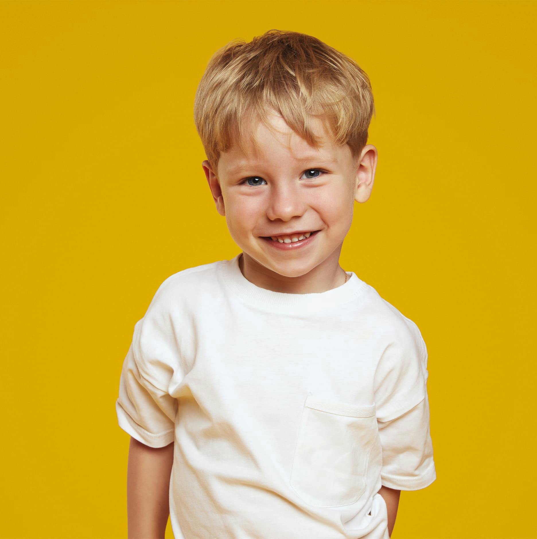 little blonde boy with yellow background