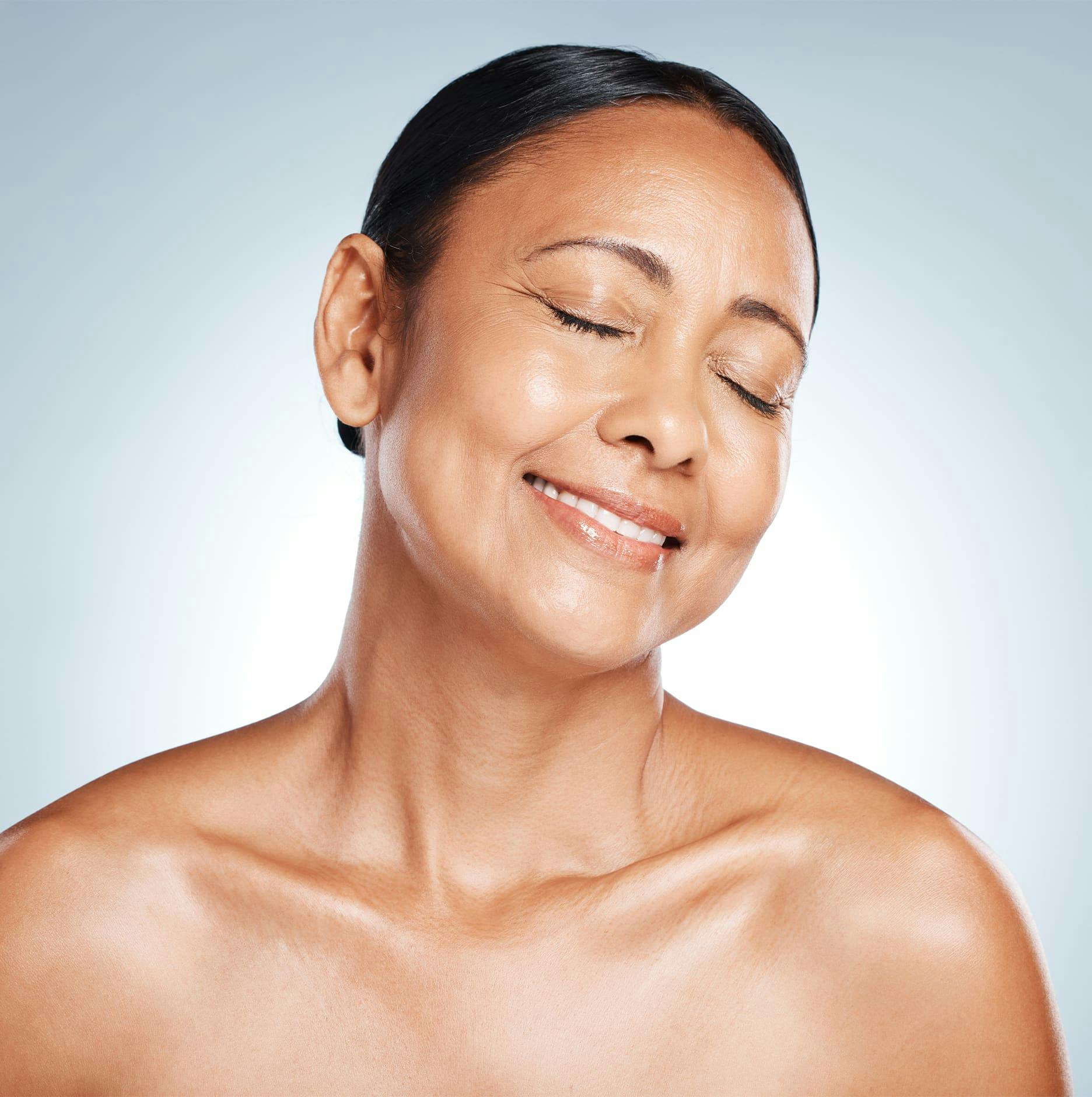 woman smiling with her collarbones popping out