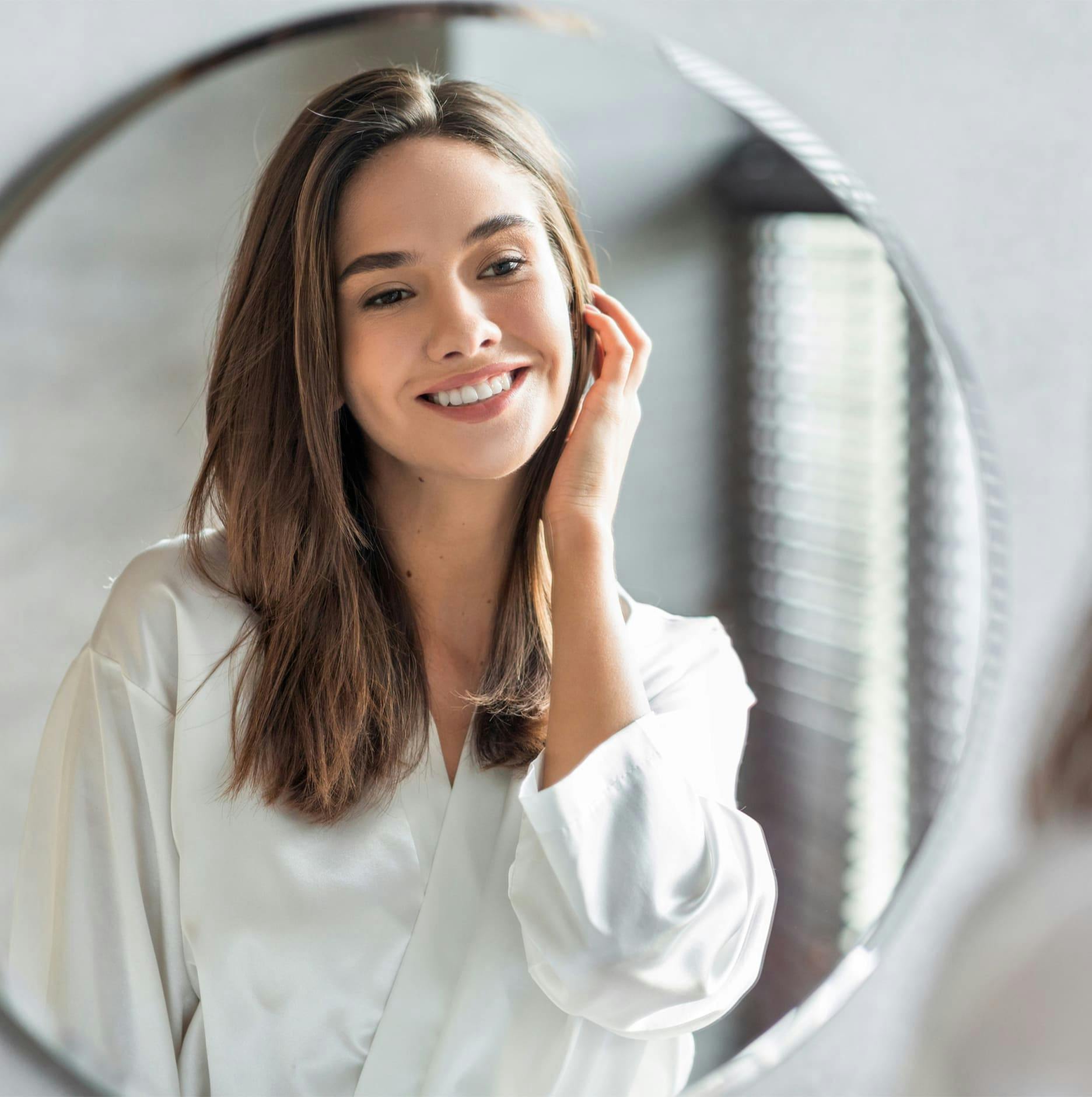 woman smiling in mirror