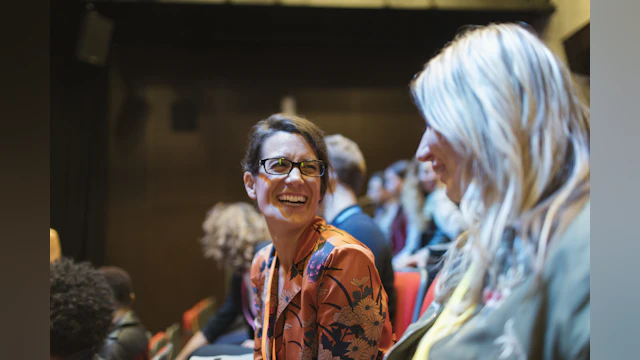 Women smiling at conference