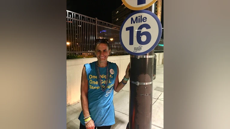 Woman standing in front of sign at walk