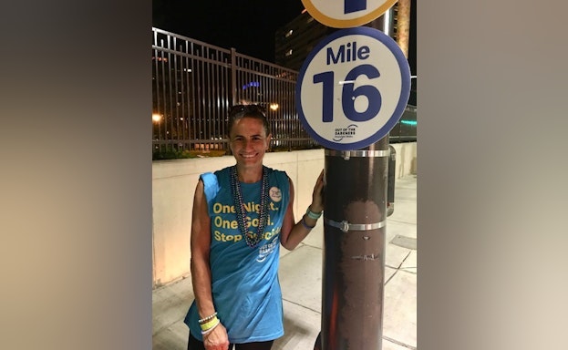 Woman standing in front of sign at walk