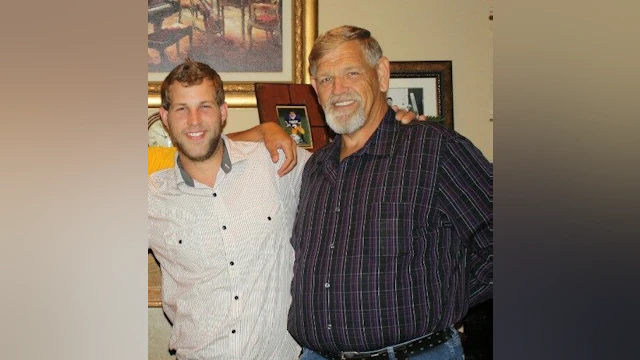 Two men smiling