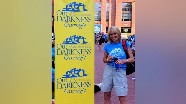 Woman standing in front of sign at walk