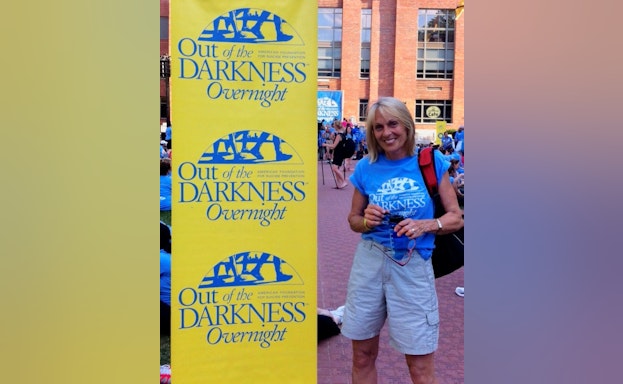 Woman standing in front of sign at walk