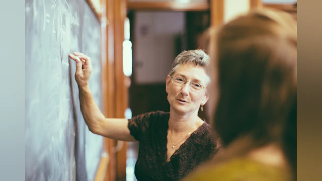 Woman at chalkboard