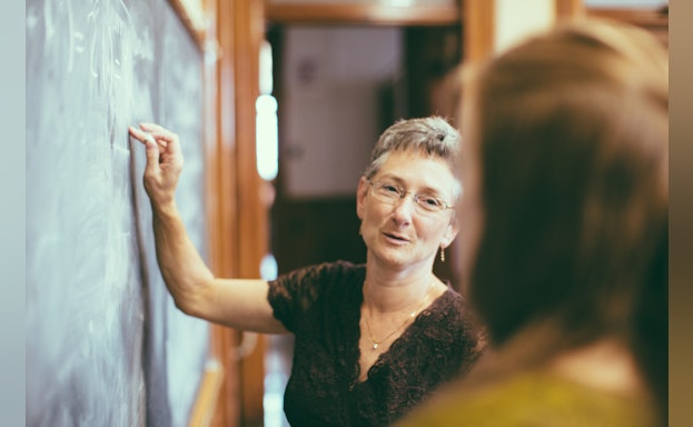 Woman at chalkboard