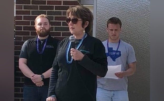 Advocates standing in front of building