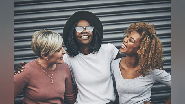 Three women smiling