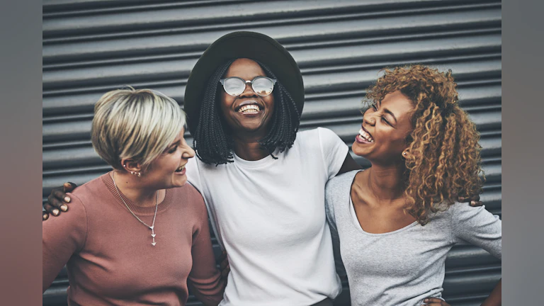 Three women smiling