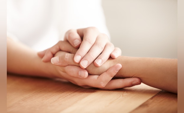 Two people holding hands