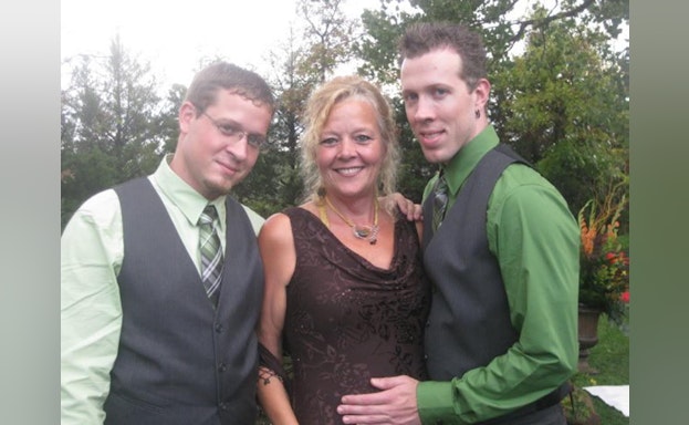 Two men and woman smiling