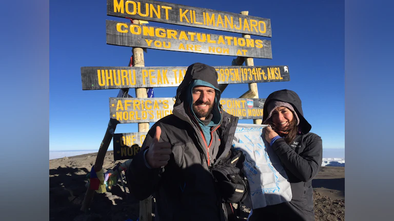 Man and woman standing at M. Kilimanjaro