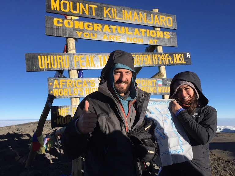 Man and woman standing at M. Kilimanjaro