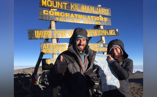 Man and woman standing at M. Kilimanjaro