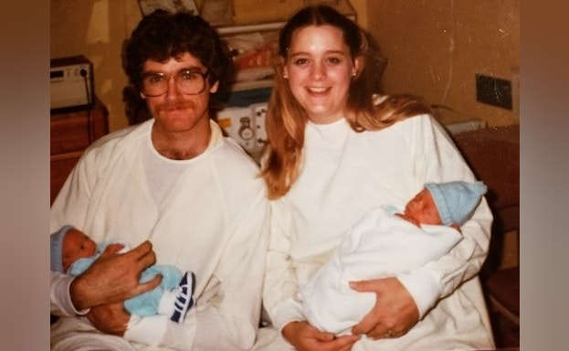 Man and woman holding babies