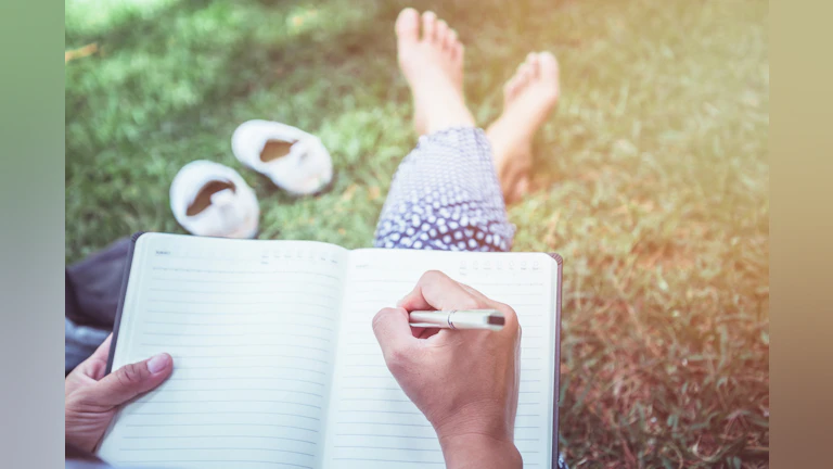 Person writing in journal