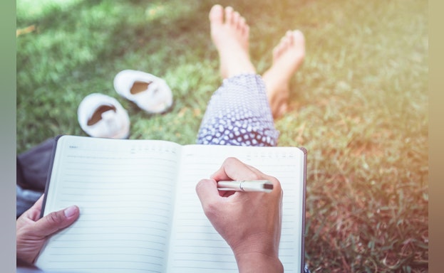 Person writing in journal