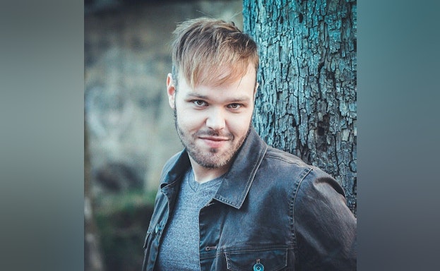 Man standing in front of tree