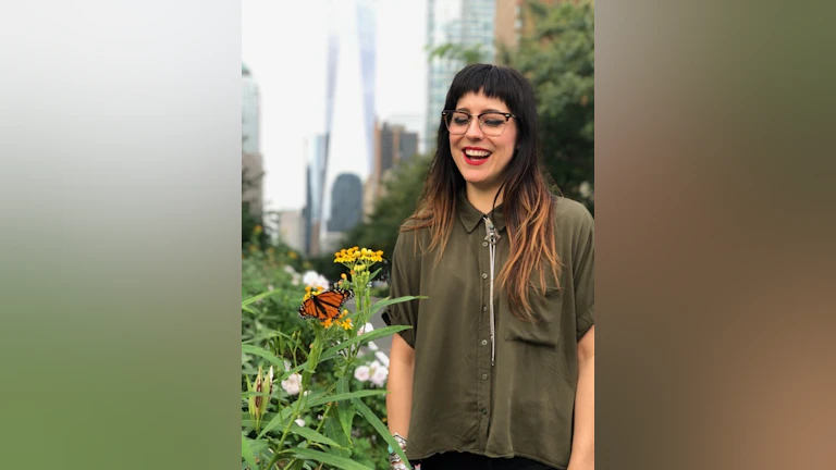 Woman smiling in front of flowers