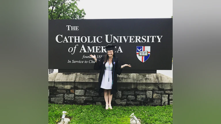 Woman in front of sign