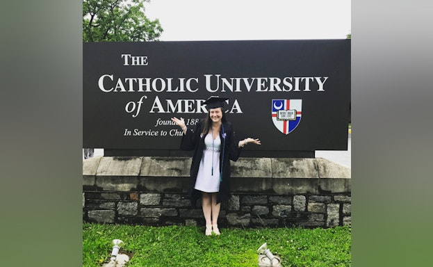 Woman in front of sign