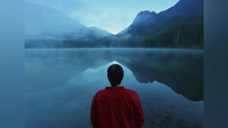 Man looking out at lake