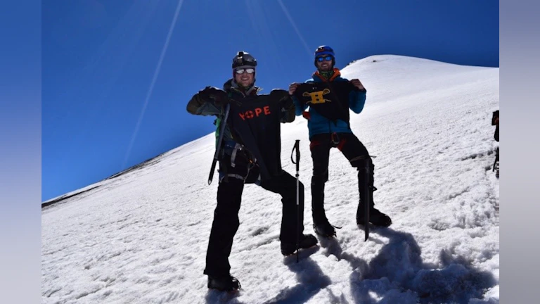 Two people standing on mountain