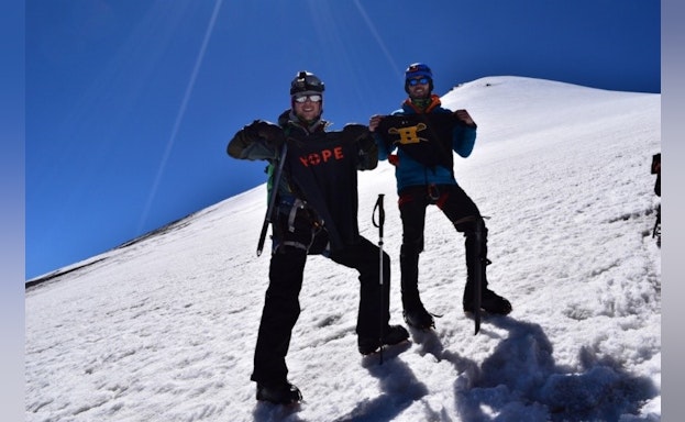 Two people standing on mountain