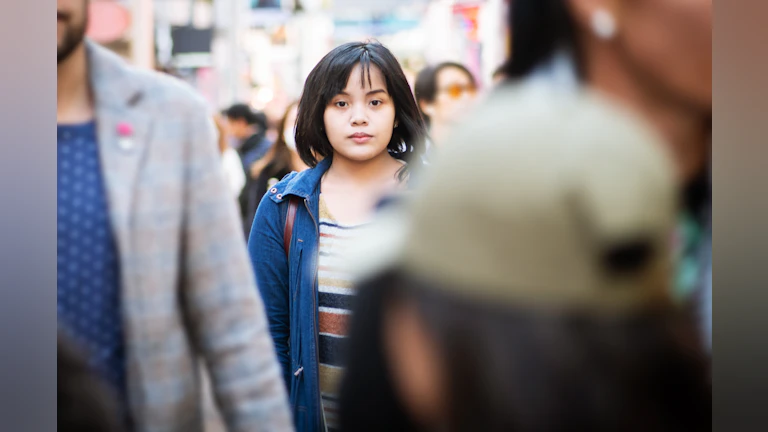 Woman walking in crowd