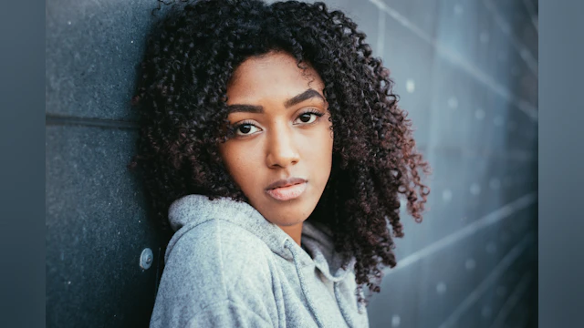 Woman leaning against a wall