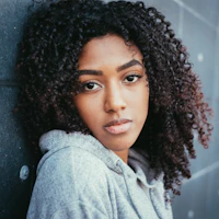 Woman leaning against a wall