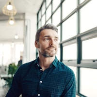 Man looking out window