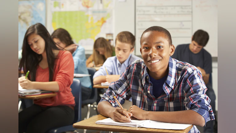 African American boy at desk in school