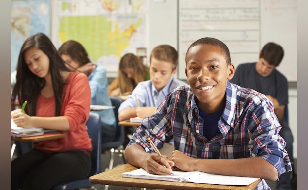 African American boy at desk in school