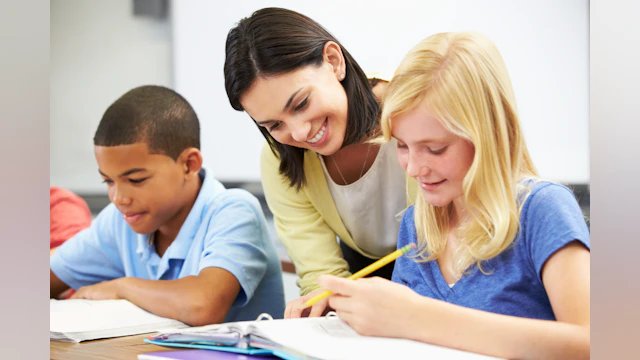 Teacher helping student with assignment