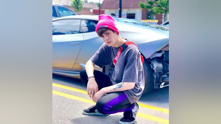 Teen in front of car