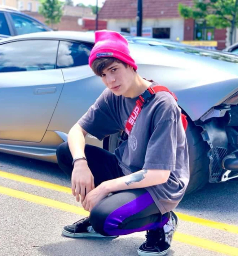 Teen in front of car