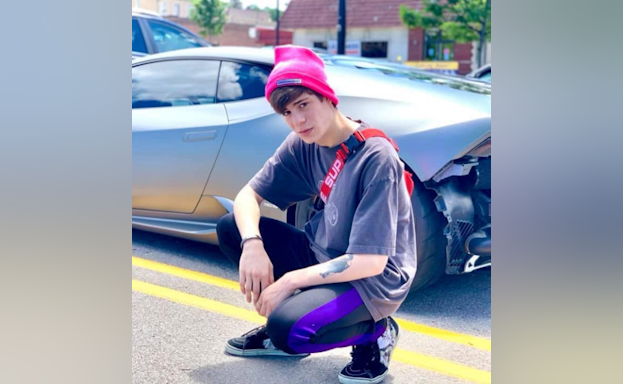 Teen in front of car