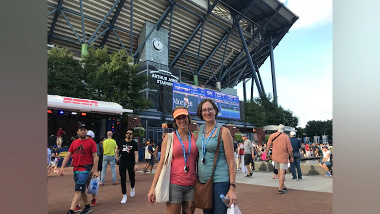 Two women standing in front of stadium
