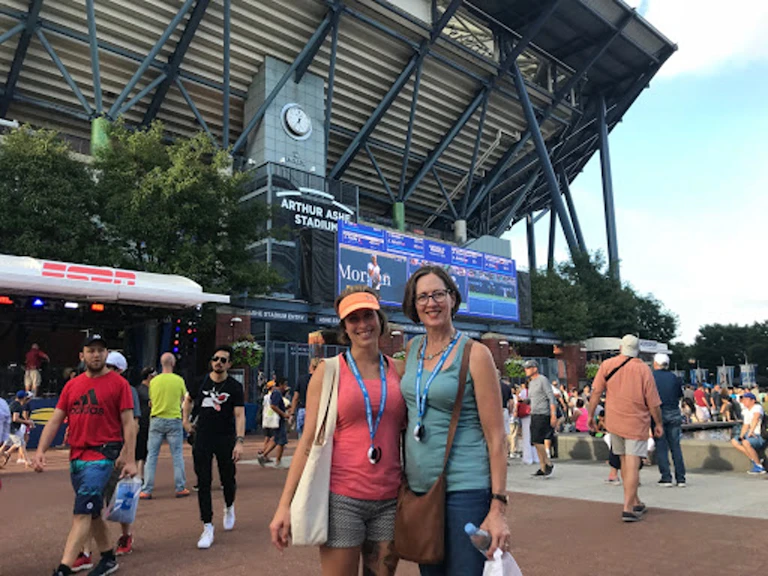 Two women standing in front of stadium