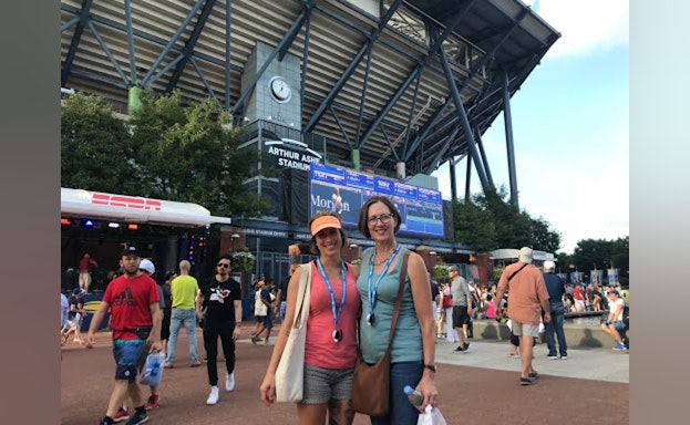 Two women standing in front of stadium