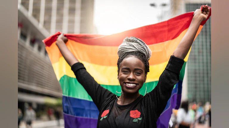 Woman holding rainbow flag