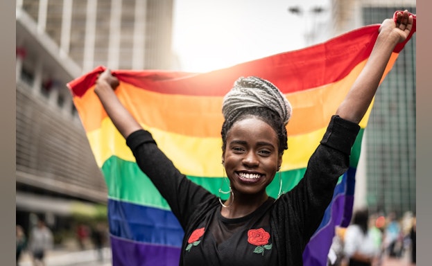 Woman holding rainbow flag